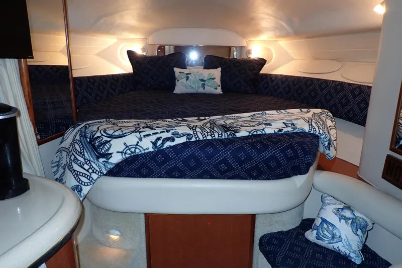Slide: The Image of Luxurious cabin interior of 2002 Sea Ray 340 Sundancer with nautical-themed bedding. - 28