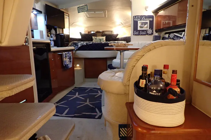Slide: The Image of Interior of 2002 Sea Ray 340 Sundancer yacht with cozy seating and bar area. - 31
