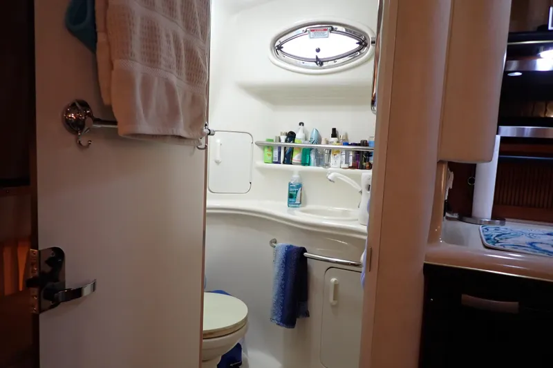 Slide: The Image of Bathroom interior of 2002 Sea Ray 340 Sundancer yacht, featuring sink and toiletries. - 35