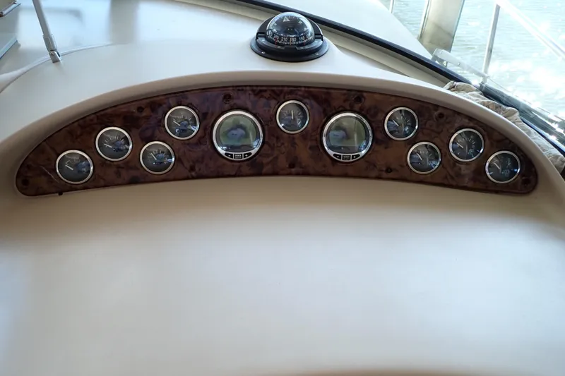 Slide: The Image of Dashboard of 2002 Sea Ray 340 Sundancer boat with multiple gauges and compass. - 38
