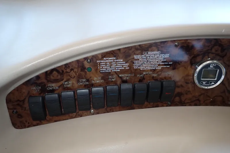 Slide: The Image of Control panel of a 2002 Sea Ray 340 Sundancer boat with various switches and a gauge. - 40