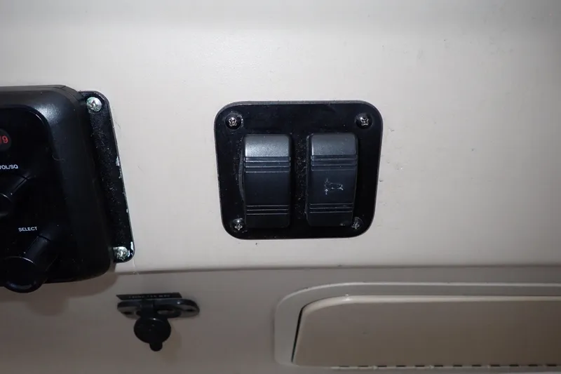 Slide: The Image of Control panel switches on a 2002 Sea Ray 340 Sundancer boat dashboard. - 46