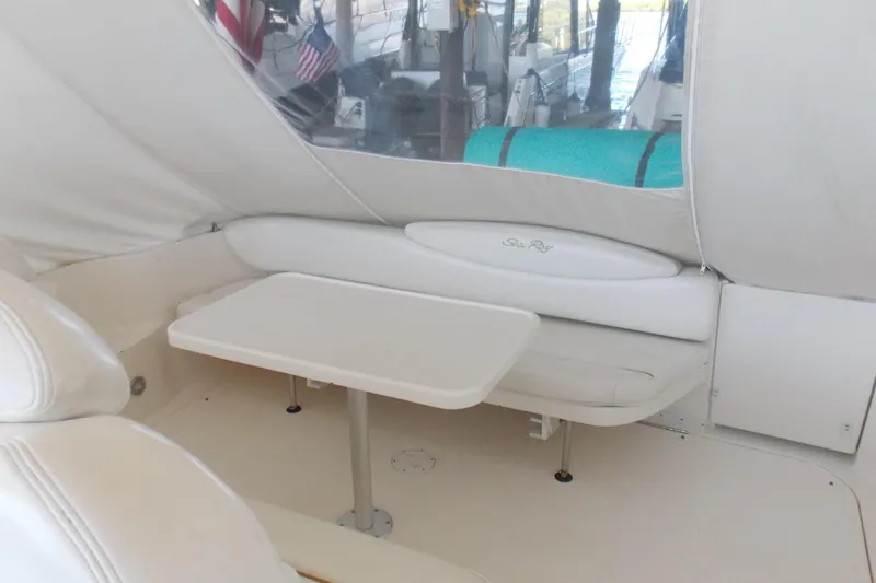 Slide: The Image of 2002 Sea Ray 340 Sundancer interior with seating and table, featuring white upholstery. - 5