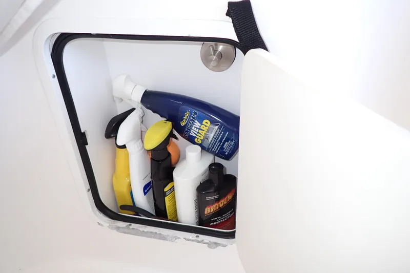 Slide: The Image of Storage compartment on 2002 Sea Ray 340 Sundancer with various cleaning products. - 53