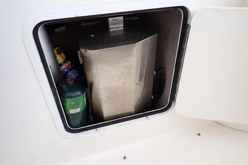 Slide: The Image of Storage compartment on a 2002 Sea Ray 340 Sundancer boat with propane tank and supplies. - 55