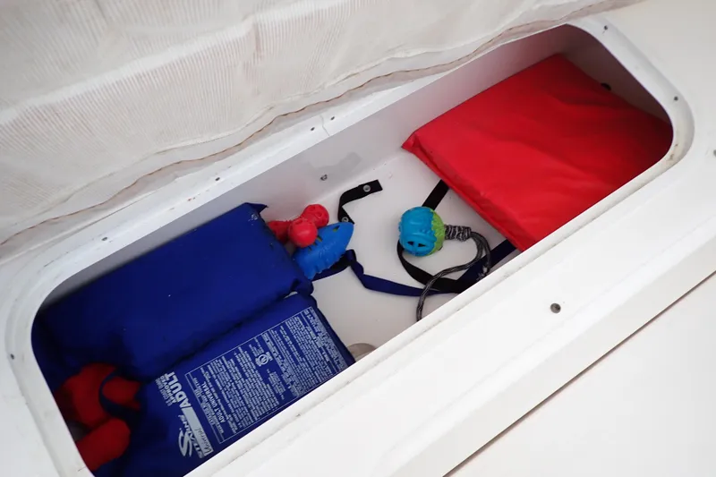 Slide: The Image of Storage compartment on 2002 Sea Ray 340 Sundancer with life jackets and toys. - 57