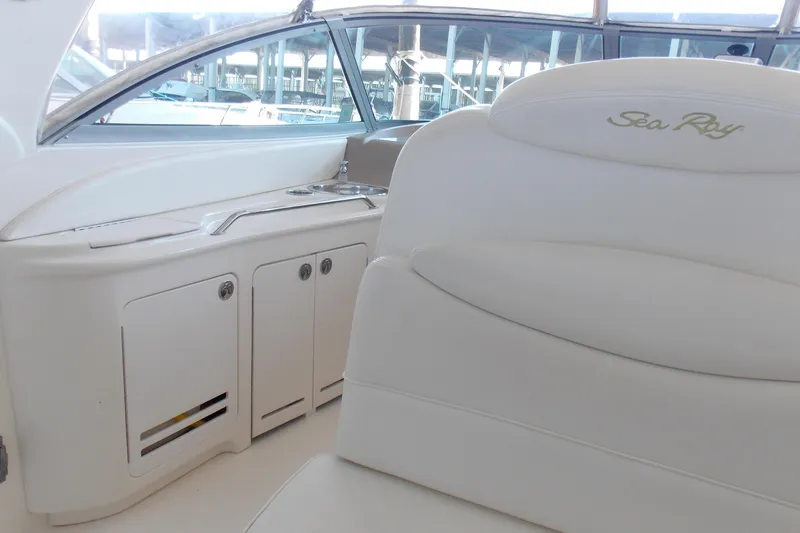 Slide: The Image of Interior of 2002 Sea Ray 340 Sundancer, featuring white seating and cabinetry. - 6