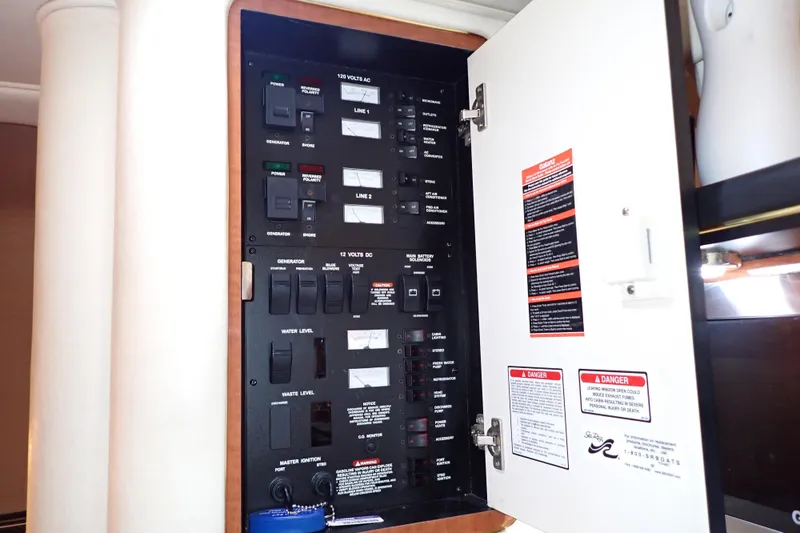 Slide: The Image of Electrical panel inside 2002 Sea Ray 340 Sundancer boat, showing switches and labels. - 65