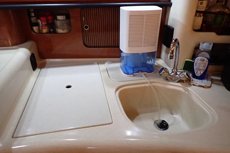 Slide: The Image of Galley sink area in 2002 Sea Ray 340 Sundancer yacht with faucet and water filter. - 68