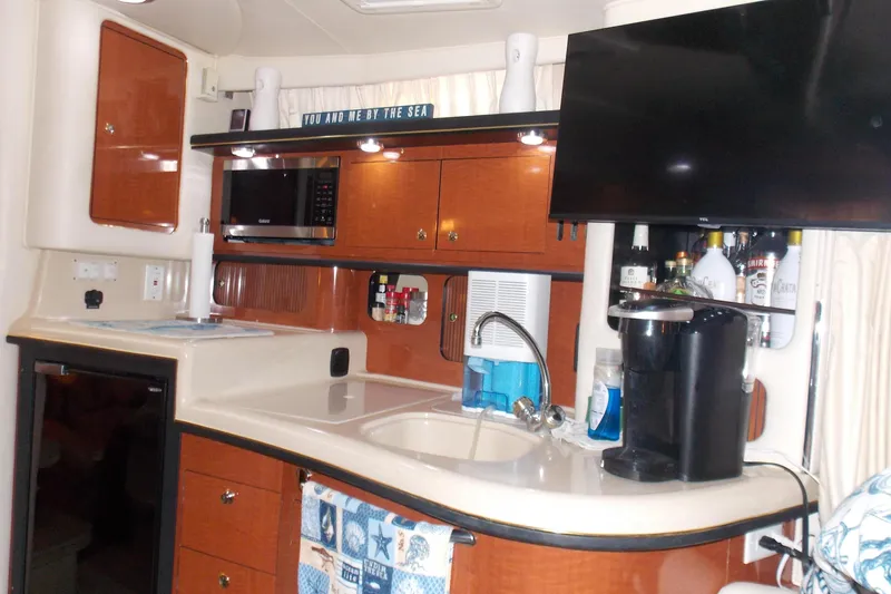 Slide: The Image of Interior of 2002 Sea Ray 340 Sundancer yacht with kitchenette and appliances. - 8