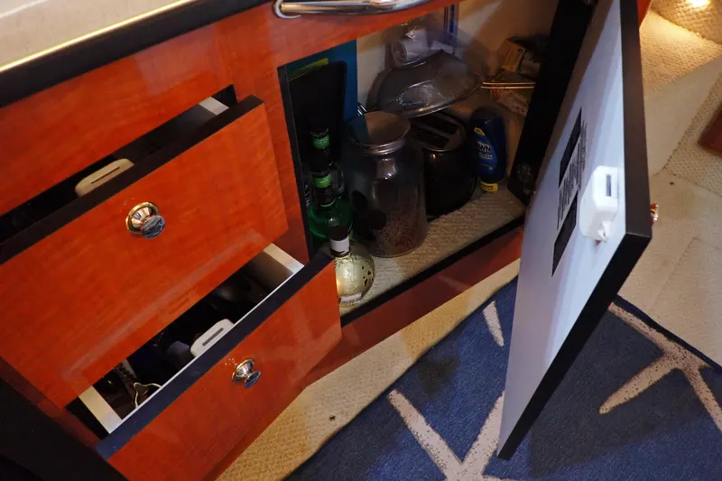 Slide: The Image of Interior storage of 2002 Sea Ray 340 Sundancer with open cabinet and drawers. - 80