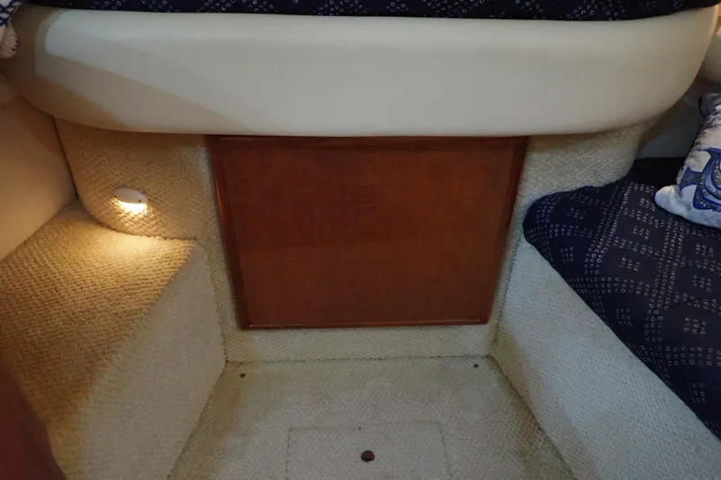 Slide: The Image of 2002 Sea Ray 340 Sundancer cabin interior with cozy lighting and patterned upholstery. - 81