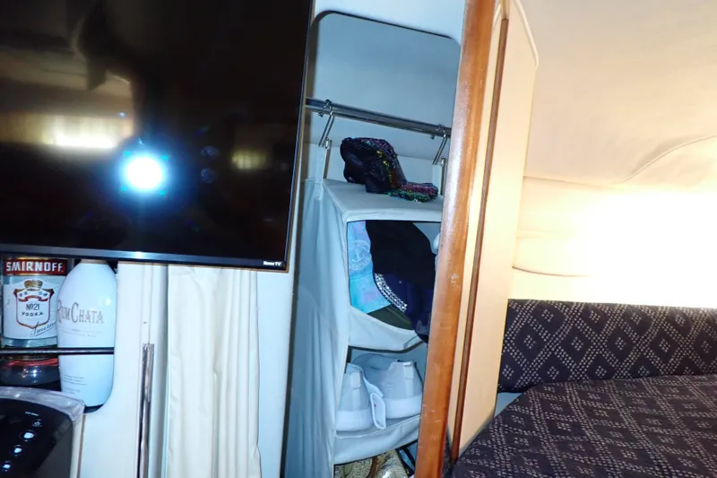 Slide: The Image of Interior of 2002 Sea Ray 340 Sundancer with TV, storage, and bed. - 90
