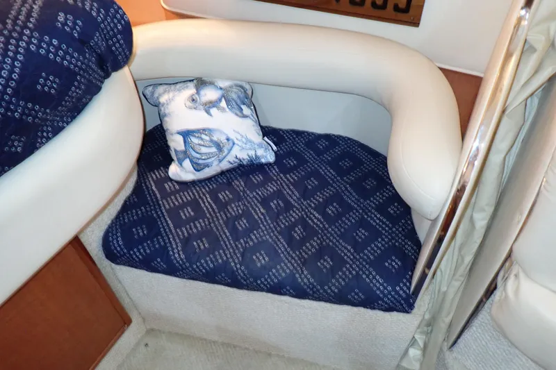 Slide: The Image of Cozy seating area on 2002 Sea Ray 340 Sundancer with nautical-themed cushion. - 93