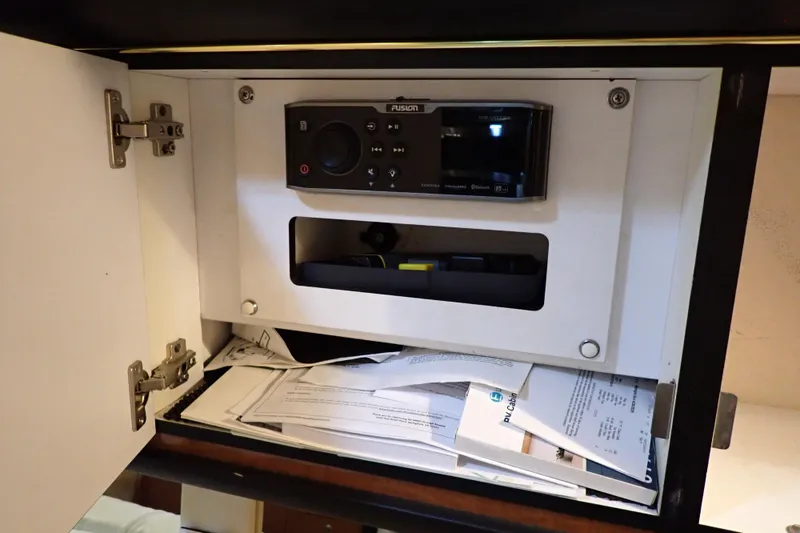 Slide: The Image of Cabinet with stereo system and documents on Sea Ray 340 Sundancer, 2002 model. - 96