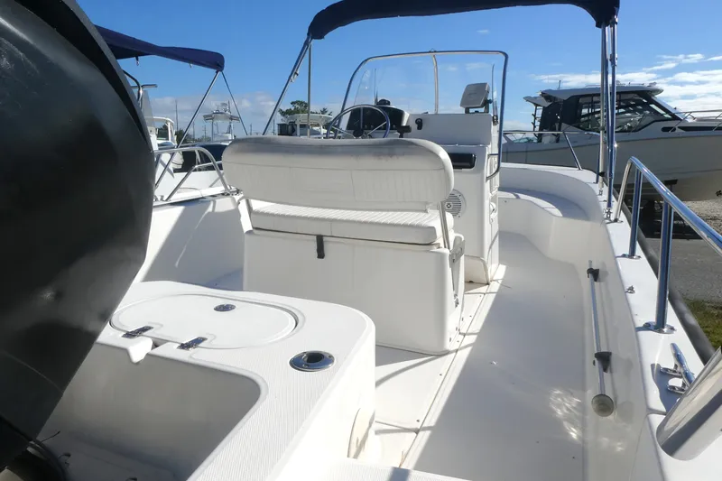 Slide: The Image of 2010 Boston Whaler 190 Montauk boat interior with seating and steering console. - 2