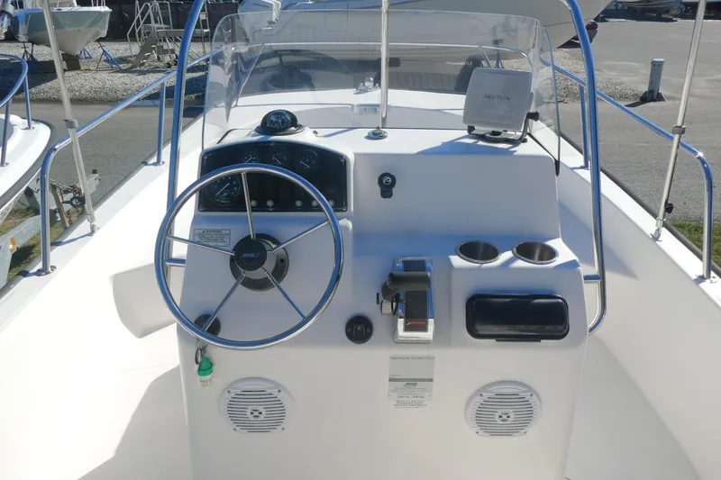 Slide: The Image of 2010 Boston Whaler 190 Montauk boat console with steering wheel and controls. - 3
