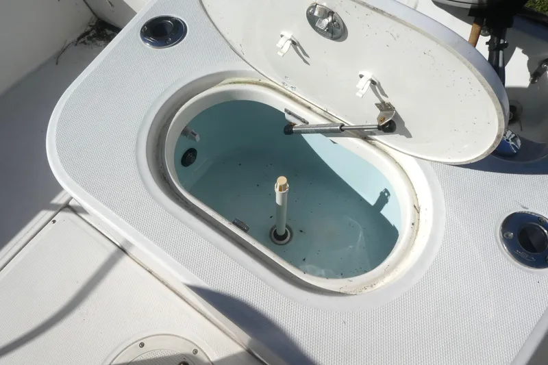 Slide: The Image of Open storage compartment on a 2010 Boston Whaler 190 Montauk boat. - 5