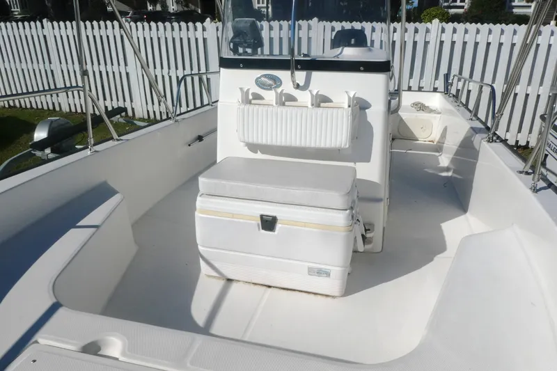 Slide: The Image of 2010 Boston Whaler 190 Montauk boat interior with seating and storage. - 8