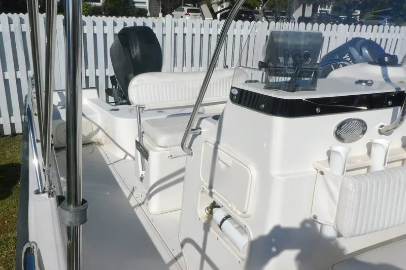 Slide: The Image of 2010 Boston Whaler 190 Montauk boat interior with white seating and navigation equipment. - 9