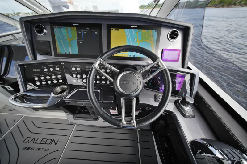 Slide: The Image of Cockpit of 2023 Galeon 400 XL yacht with advanced navigation displays and controls. - 14