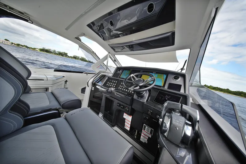 Slide: The Image of Interior view of 2023 Galeon 400 XL yacht cockpit with modern controls and seating. - 23