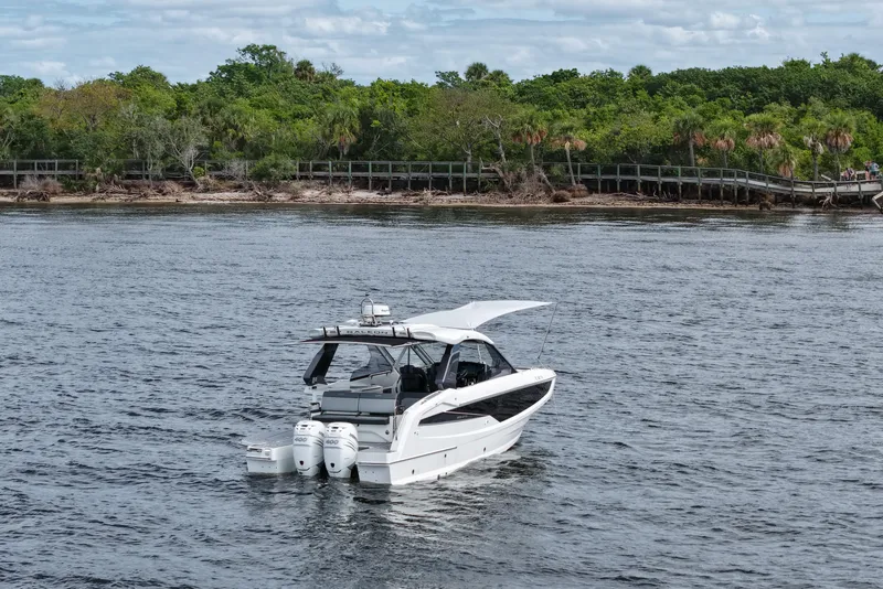 Slide: The Image of 2023 Galeon 400 XL yacht cruising near lush shoreline. - 47