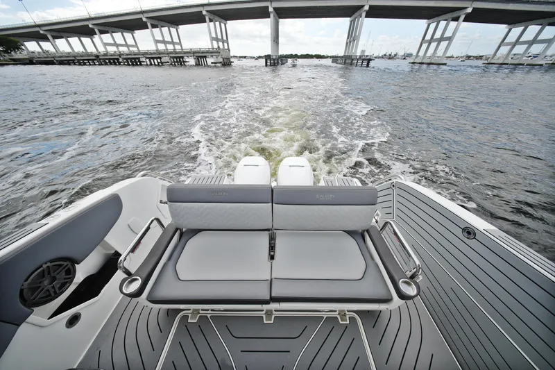 Slide: The Image of 2023 Galeon 400 XL boat cruising under a bridge, showcasing sleek seating and design. - 5