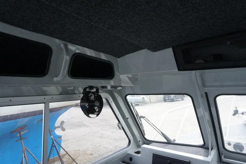 Slide: The Image of Interior of 2023 Weldcraft 220 Ocean King boat, featuring windows and fan. - 11