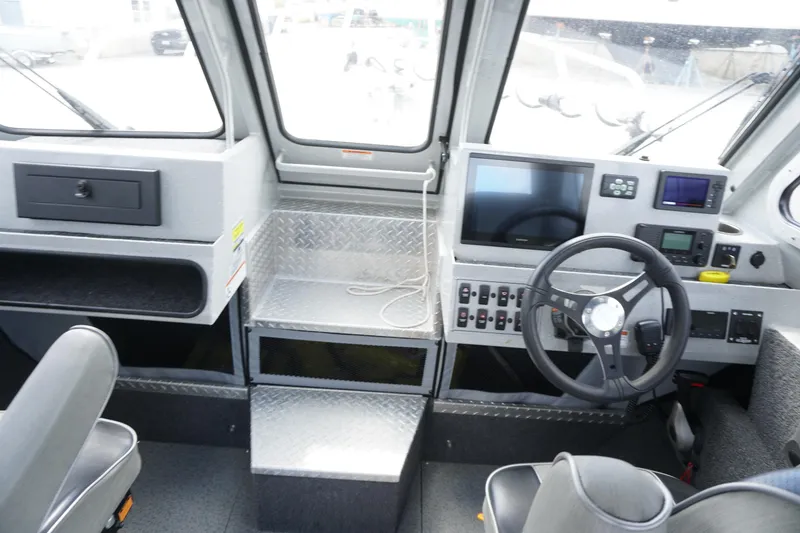 Slide: The Image of 2023 Weldcraft 220 Ocean King boat interior with steering wheel and control panel. - 12