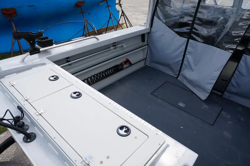 Slide: The Image of 2023 Weldcraft 220 Ocean King boat interior with storage compartments and seating area. - 15