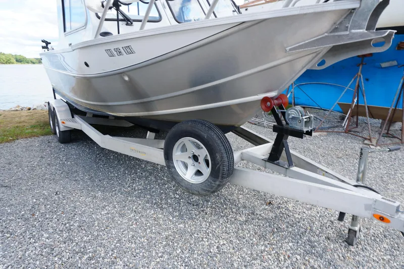 Slide: The Image of 2023 Weldcraft 220 Ocean King boat on trailer, parked on gravel near water. - 16