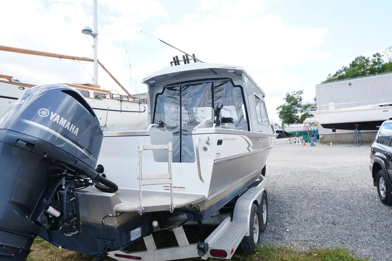 Slide: The Image of 2023 Weldcraft 220 Ocean King boat with Yamaha engine on trailer in marina setting. - 4