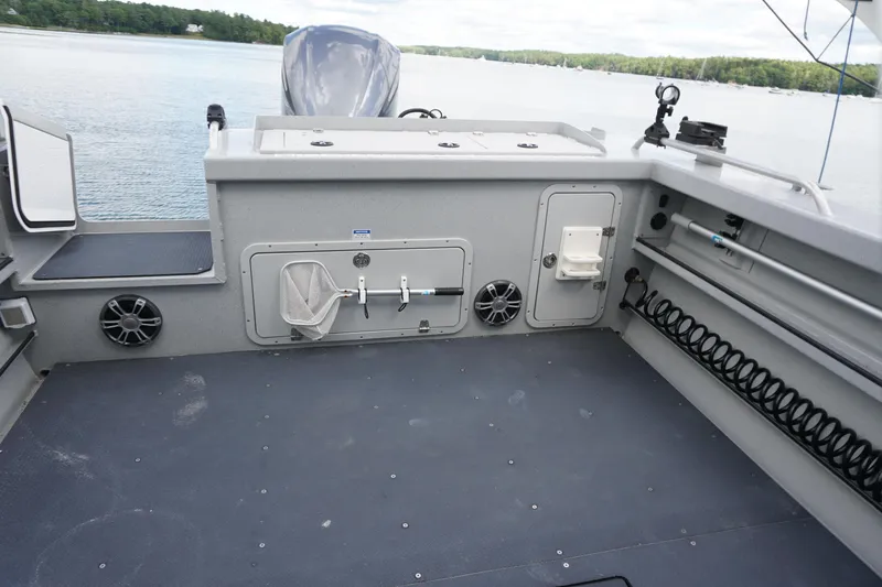Slide: The Image of 2023 Weldcraft 220 Ocean King boat interior with fishing equipment and storage compartments. - 9