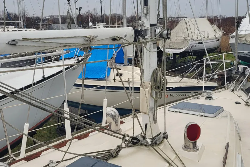 Slide: The Image of 1986 Sabre 34 sailboat in a marina, surrounded by other docked boats. - 12