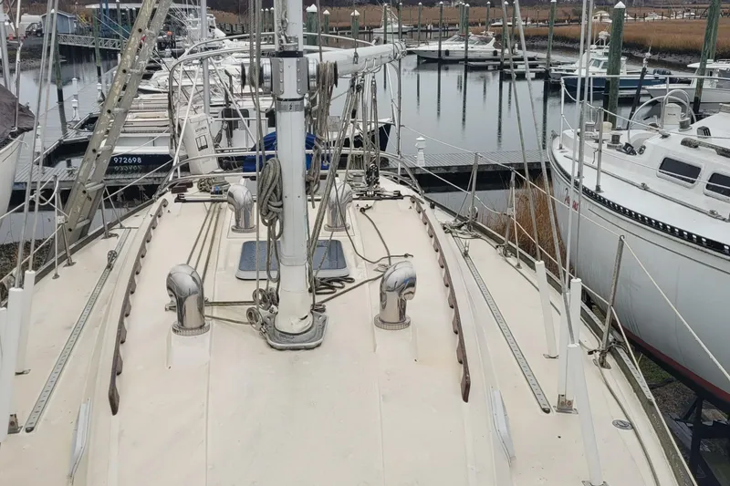 Slide: The Image of 1986 Sabre 34 sailboat deck view in marina, surrounded by other boats. - 15