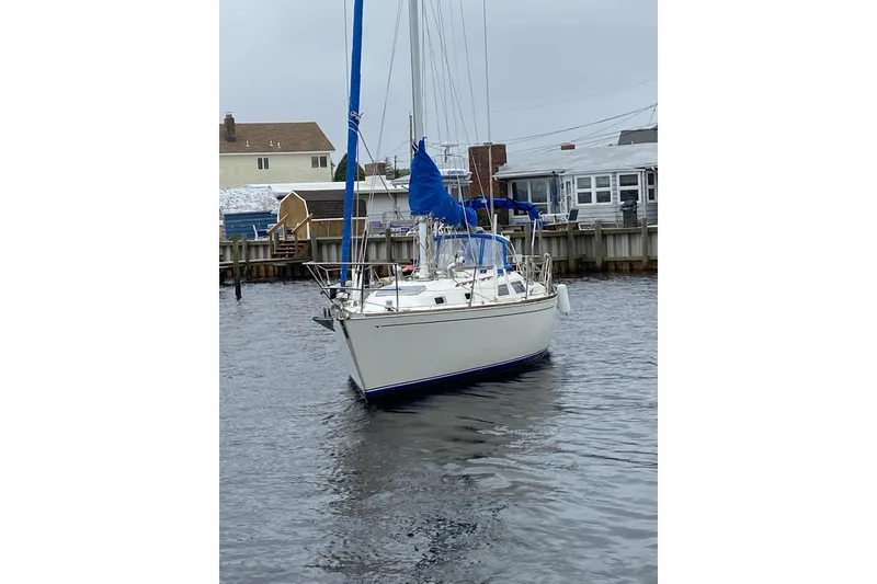 Slide: The Image of 1986 Sabre MK 34 sailboat docked in a calm marina setting. - 2