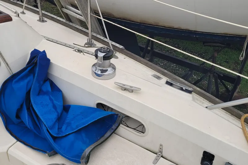 Slide: The Image of 1986 Sabre 34 sailboat deck with blue cover and winch. - 22