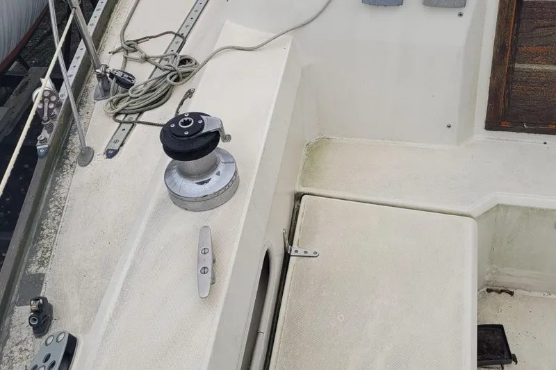 Slide: The Image of 1986 Sabre 34 sailboat deck with winch, cleat, and rigging details. - 23