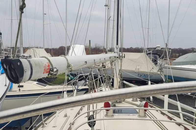 Slide: The Image of 1986 Sabre 34 sailboat mast and deck view in a marina setting. - 24