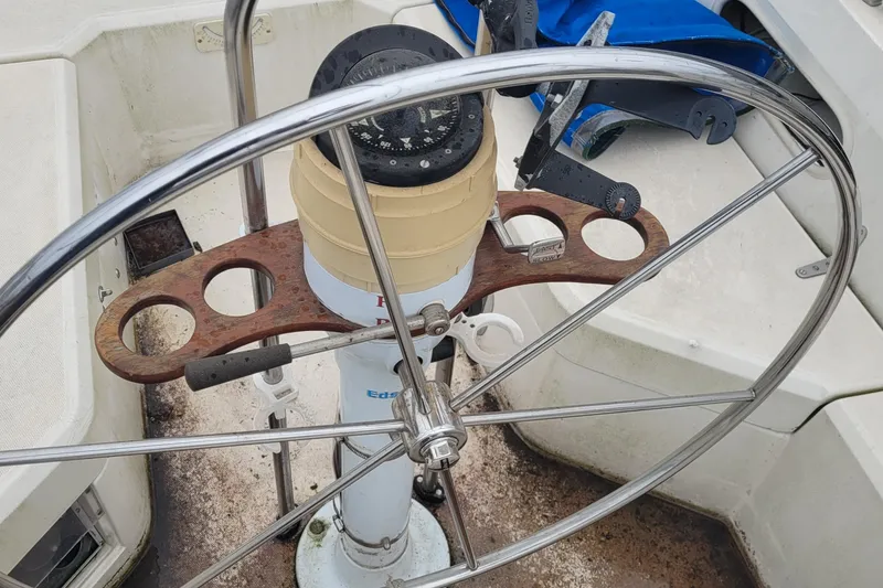 Slide: The Image of Steering wheel and compass of a 1986 Sabre 34 sailboat cockpit. - 25