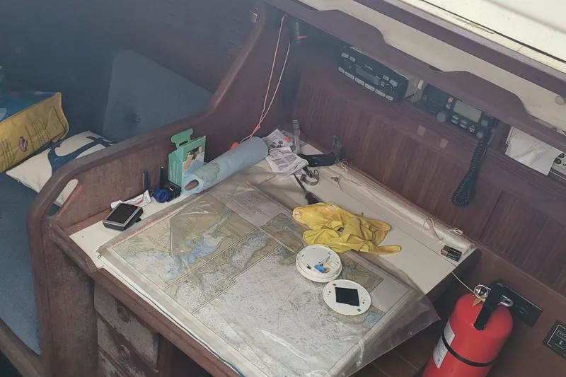 Slide: The Image of Navigation station on 1986 Sabre 34 sailboat with map, radio, and safety equipment. - 27