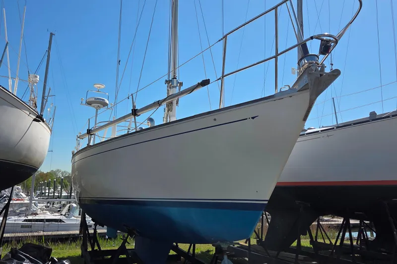 Slide: The Image of 1986 Sabre 34 sailboat on dry dock, blue hull, clear sky background. - 32