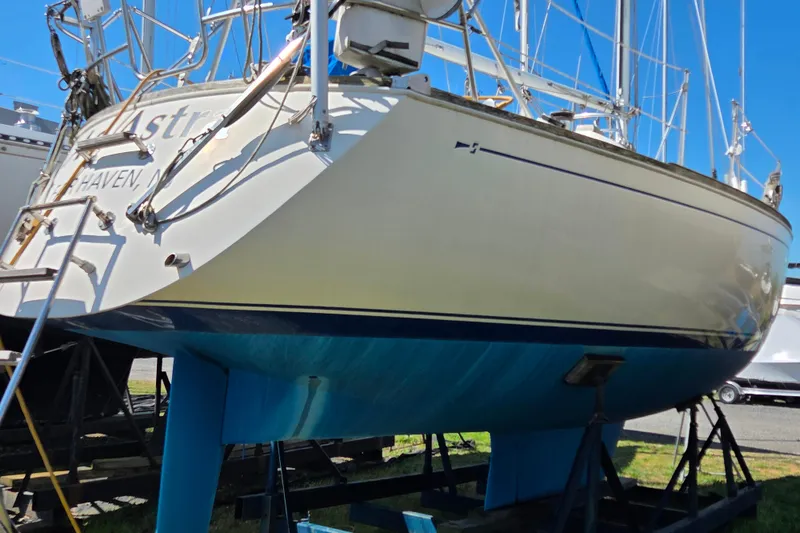Slide: The Image of 1986 Sabre 34 sailboat on stands, showcasing hull and deck details. - 33