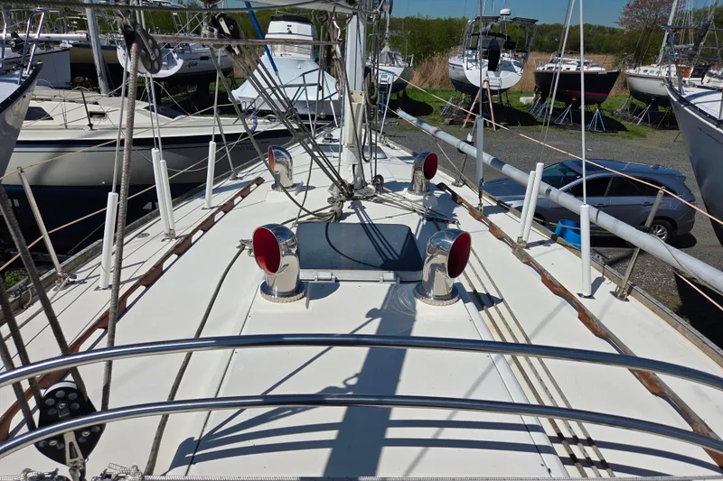 Slide: The Image of 1986 Sabre 34 sailboat deck with rigging and chrome vents in a marina. - 36