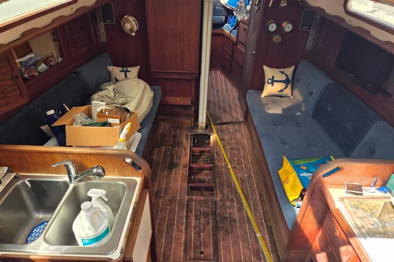 Slide: The Image of Interior of a 1986 Sabre 34 sailboat with wooden flooring and cozy seating. - 43