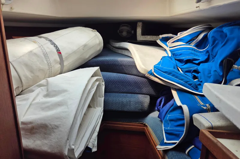 Slide: The Image of Interior of a 1986 Sabre 34 sailboat with stored sails and cushions. - 46