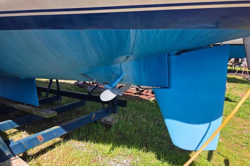 Slide: The Image of 1986 Sabre 34 sailboat hull and propeller on a trailer, painted blue. - 48