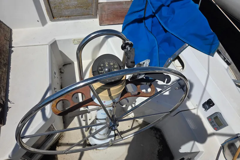 Slide: The Image of Steering wheel and compass of a 1986 Sabre 34 sailboat cockpit. - 49