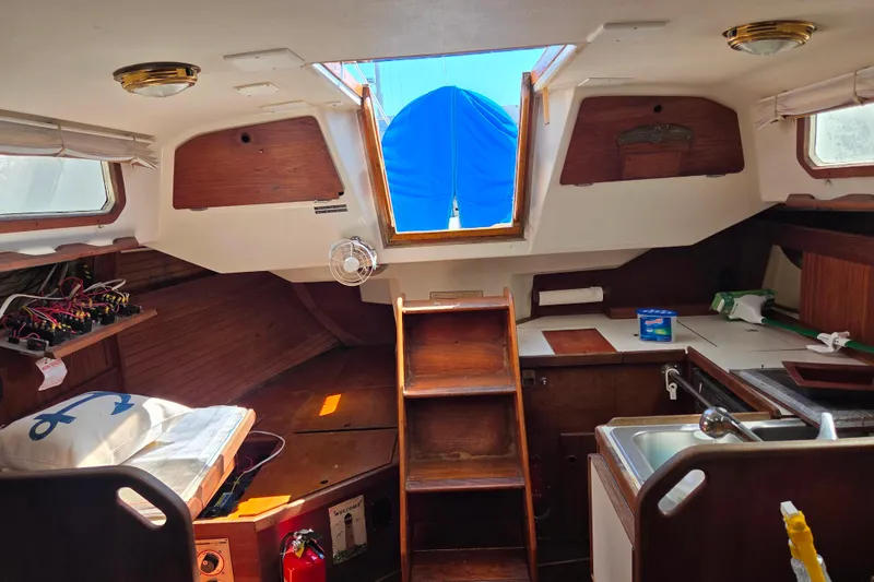 Slide: The Image of Interior of a 1986 Sabre 34 sailboat with wooden cabinetry and compact kitchen. - 50